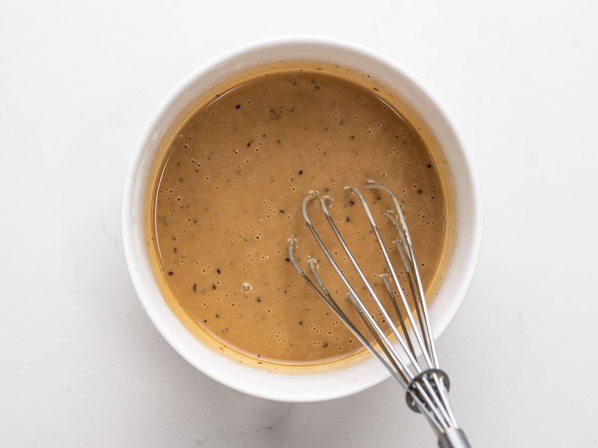 Creamy Balsamic Vinaigrette in a bowl with a whisk.