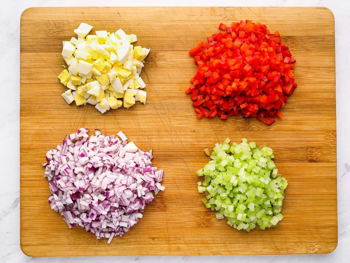 Chopped salad ingredients on a cutting board.