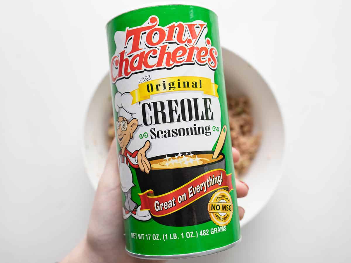 A container of tony's seasoning held close to the camera.