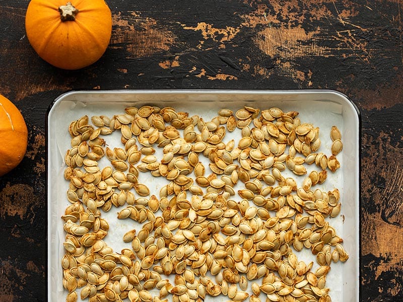 Roasted pumpkin seeds on a baking sheet