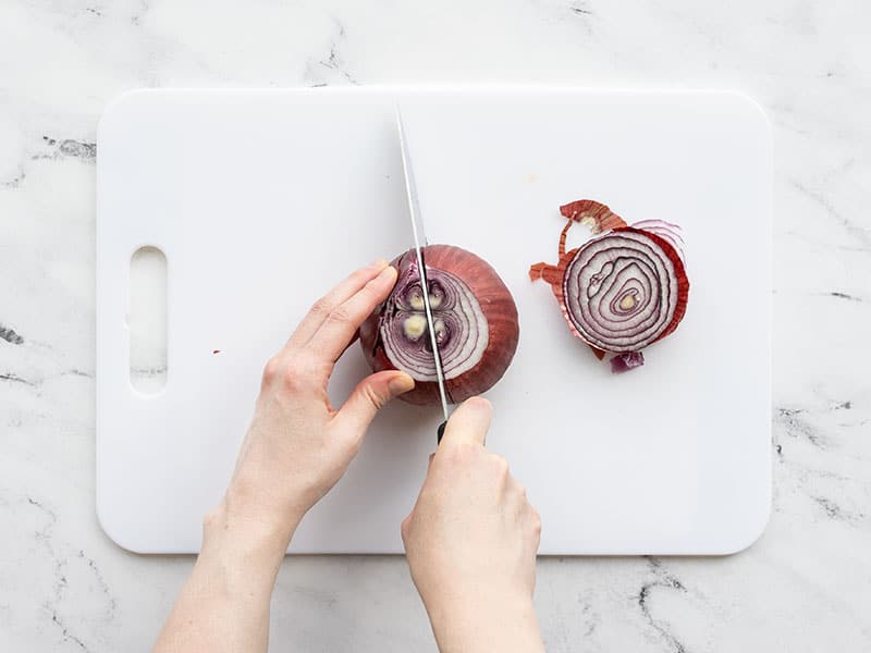 Onion being sliced in half