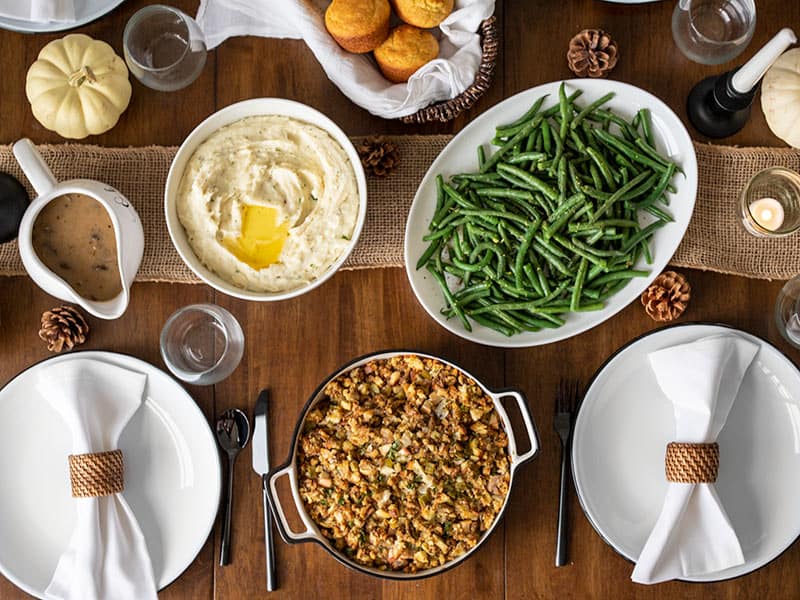 Overhead view of a table full of Thanksgiving side dishes