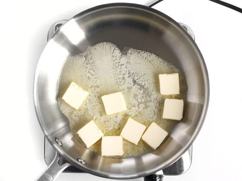 Pats of Butter in the skillet, beginning to melt