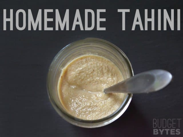 Homemade Tahini in jar with spoon 