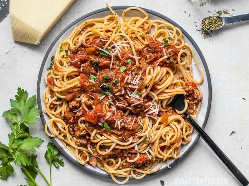 A large plate full of spaghetti and The Best Weeknight Pasta Sauce wrapped around a fork