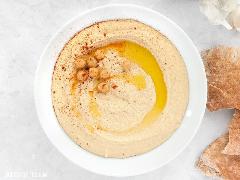 Bowl of Homemade Hummus garnished with chickpeas, olive oil, and paprika.