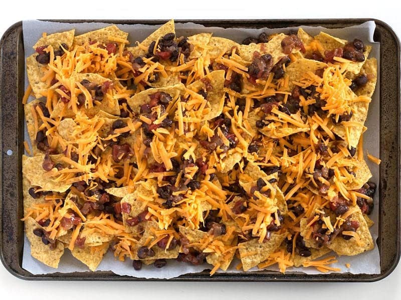 Two Layers of Chips Beans and Cheese on the baking sheet