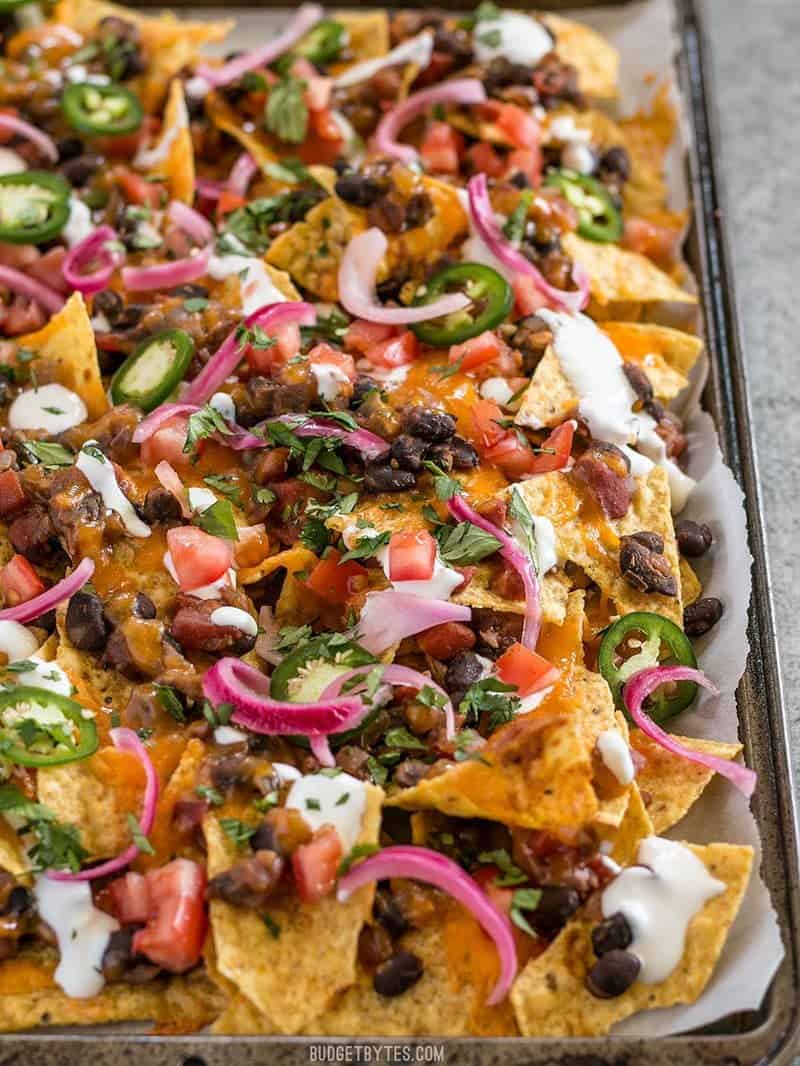 Close up of the sheet pan full of Spicy Baked Black Bean Nachos