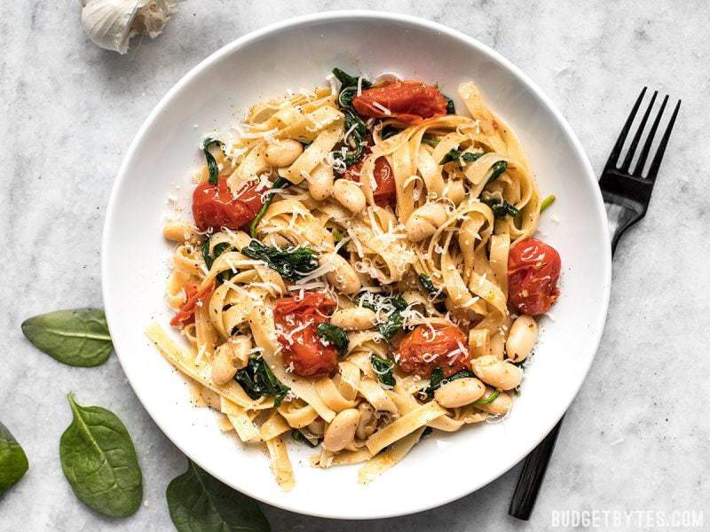 This Tuscan White Bean Pasta is a fast and flavorful dish that is perfect for weeknight dinners. The caramelized garlic, basil, and Parmesan pack a huge flavor punch!
