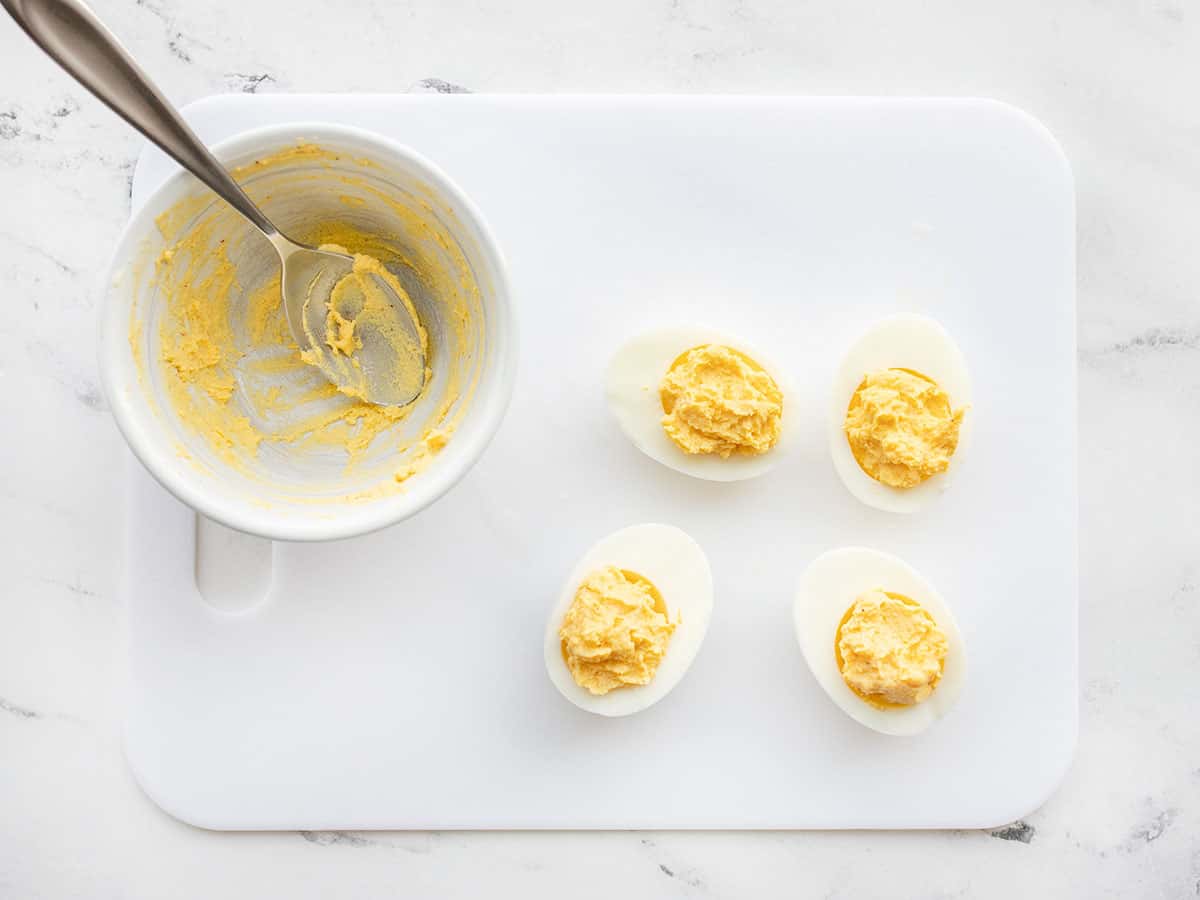 Mashed and seasoned yolk returned to the egg whites
