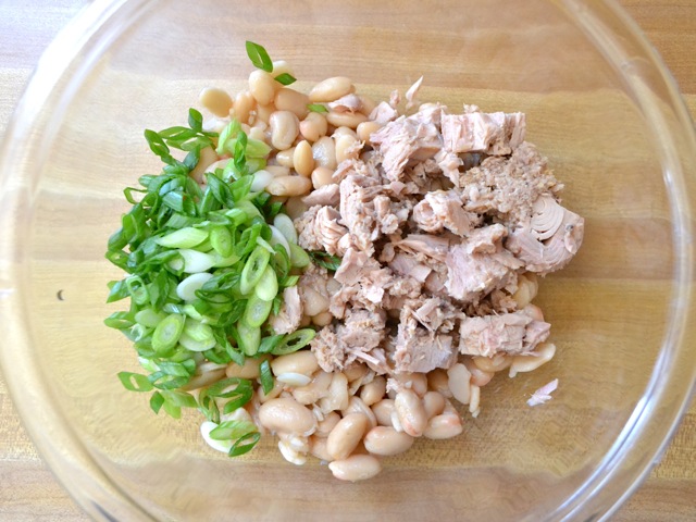 white beans, tuna and green onion in mixing bowl 
