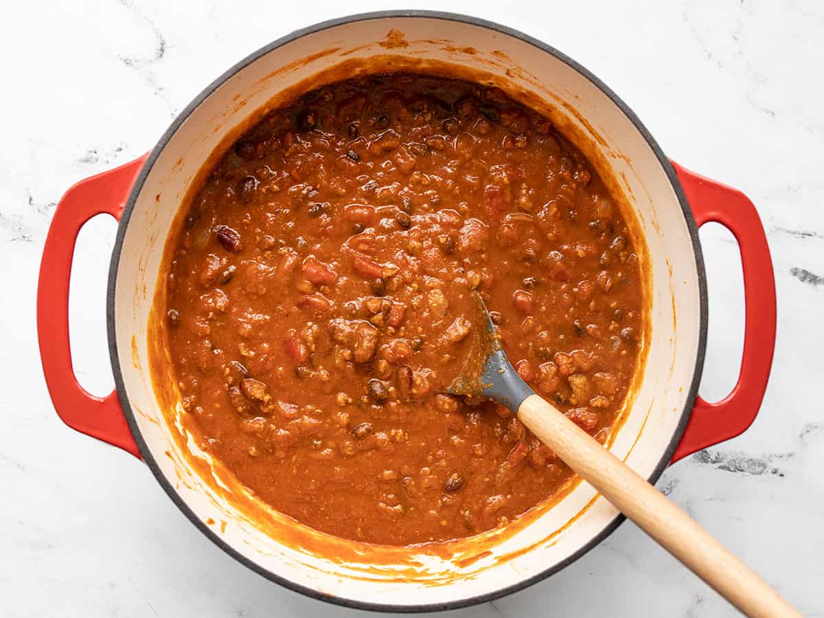 simmered chili in a pot with a spoon
