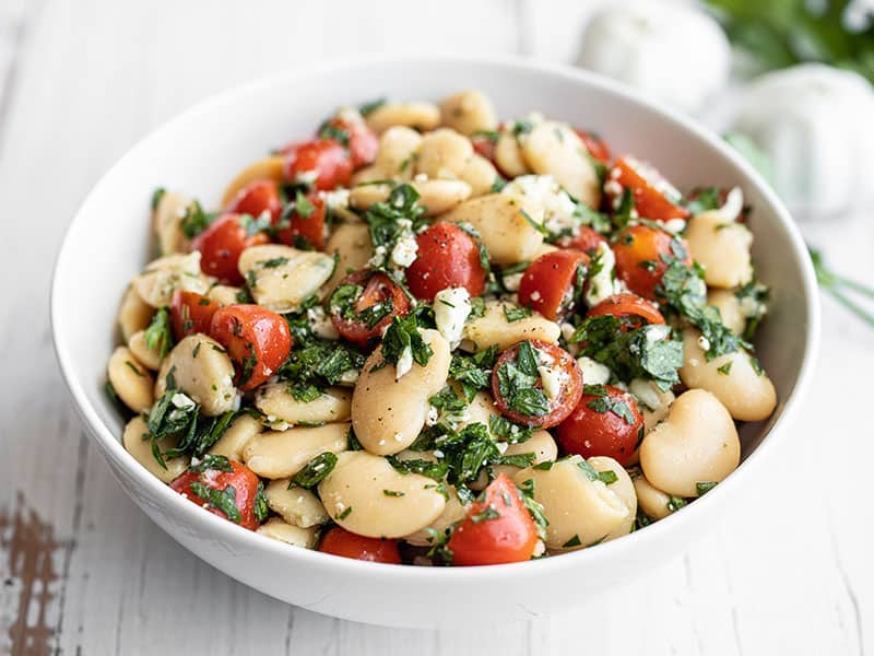 Front view of a bow full of mediterranean white bean salad
