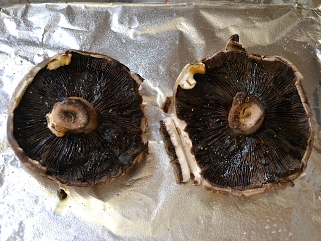 seasoned mushrooms placed on baking sheet lined with tin foil 