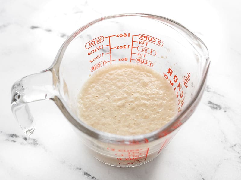 Foamy yeast water in a glass measuring cup