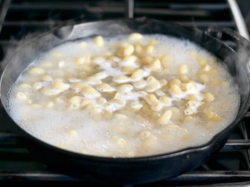 Pasta boiling in a cast iron skillet