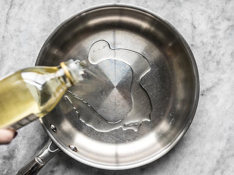 Add high heat oil to a skillet