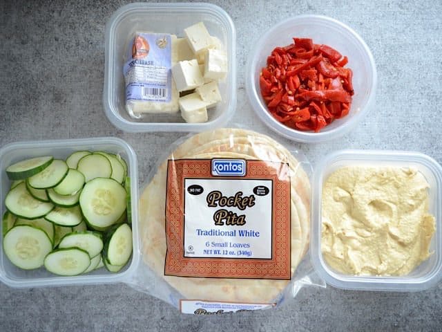 Ingredients for hummus wraps in individual containers