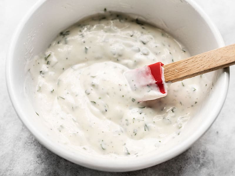 Finished Homemade Ranch Dressing in a bowl with a red spatula.