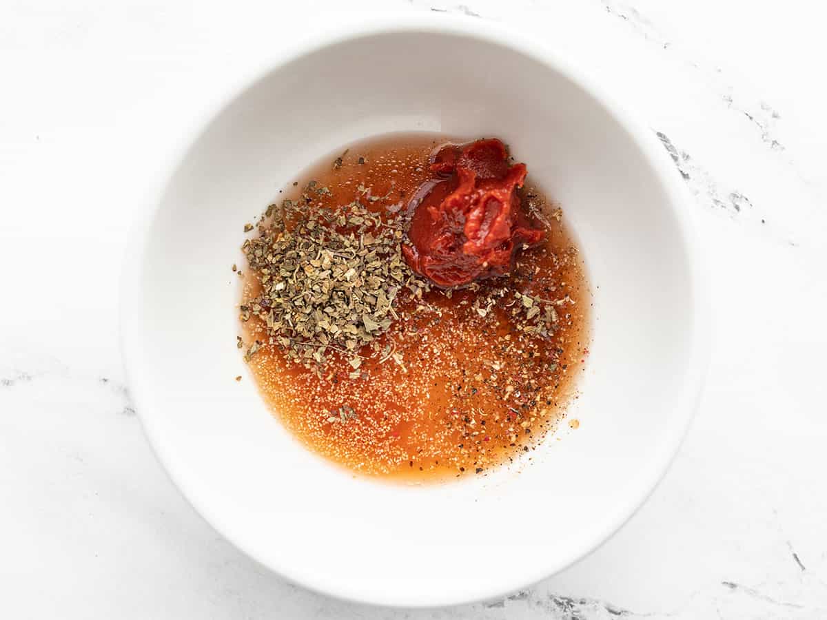 tomato paste, vinegar, and herbs in a bowl