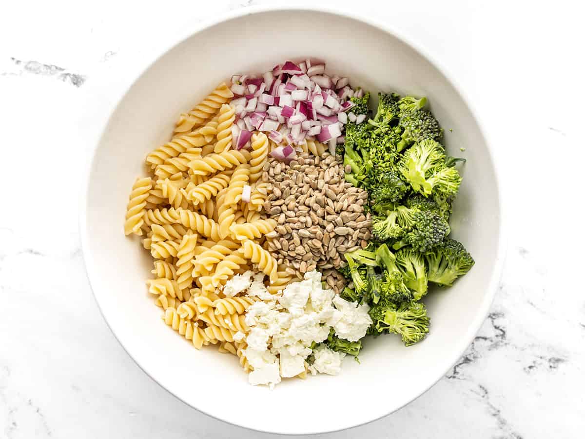 Broccoli pasta salad ingredients in a bowl