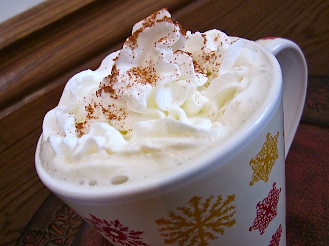 close up of finished tea in mug with whipped cream 