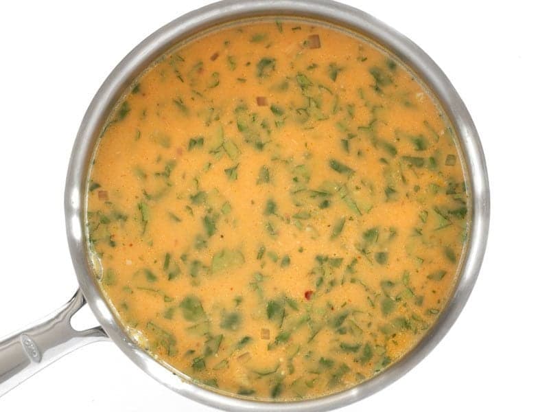 Top view of inished Spicy Coconut and Pumpkin Soup in pot 