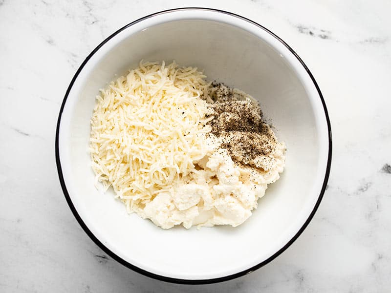 Ricotta, Italian cheese, and black pepper in a bowl