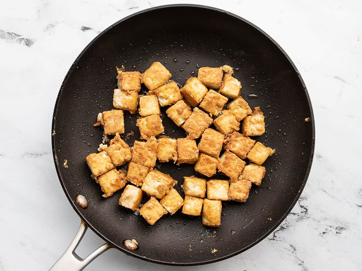 cooked tofu cubes in a skillet