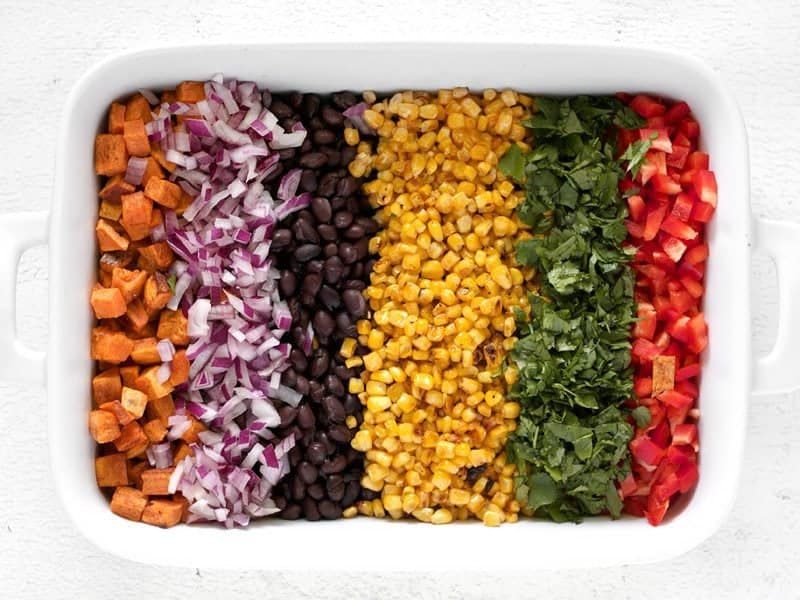 Rainbow Salad Ingredients in a large serving dish, each ingredient separate in a row like a rainbow