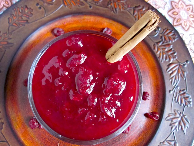 red wine cranberry sauce in bowl with cinnamon stick 