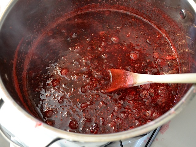 top view of finished sauce with wooden mixing spoon 