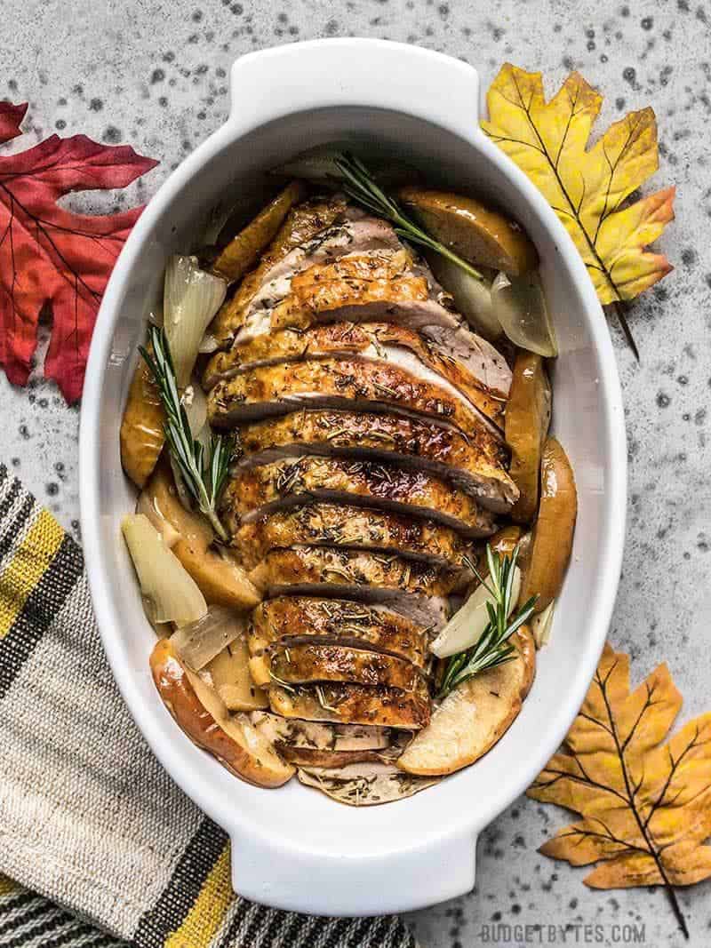 Cider Roasted Turkey Breast sliced and ready to serve with roasted apples and onions.