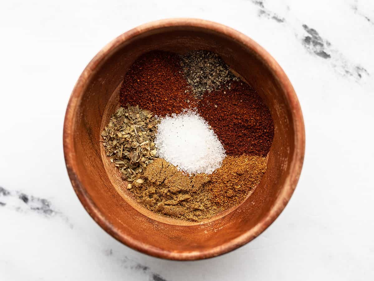 Taco seasoning spices in a small wooden bowl
