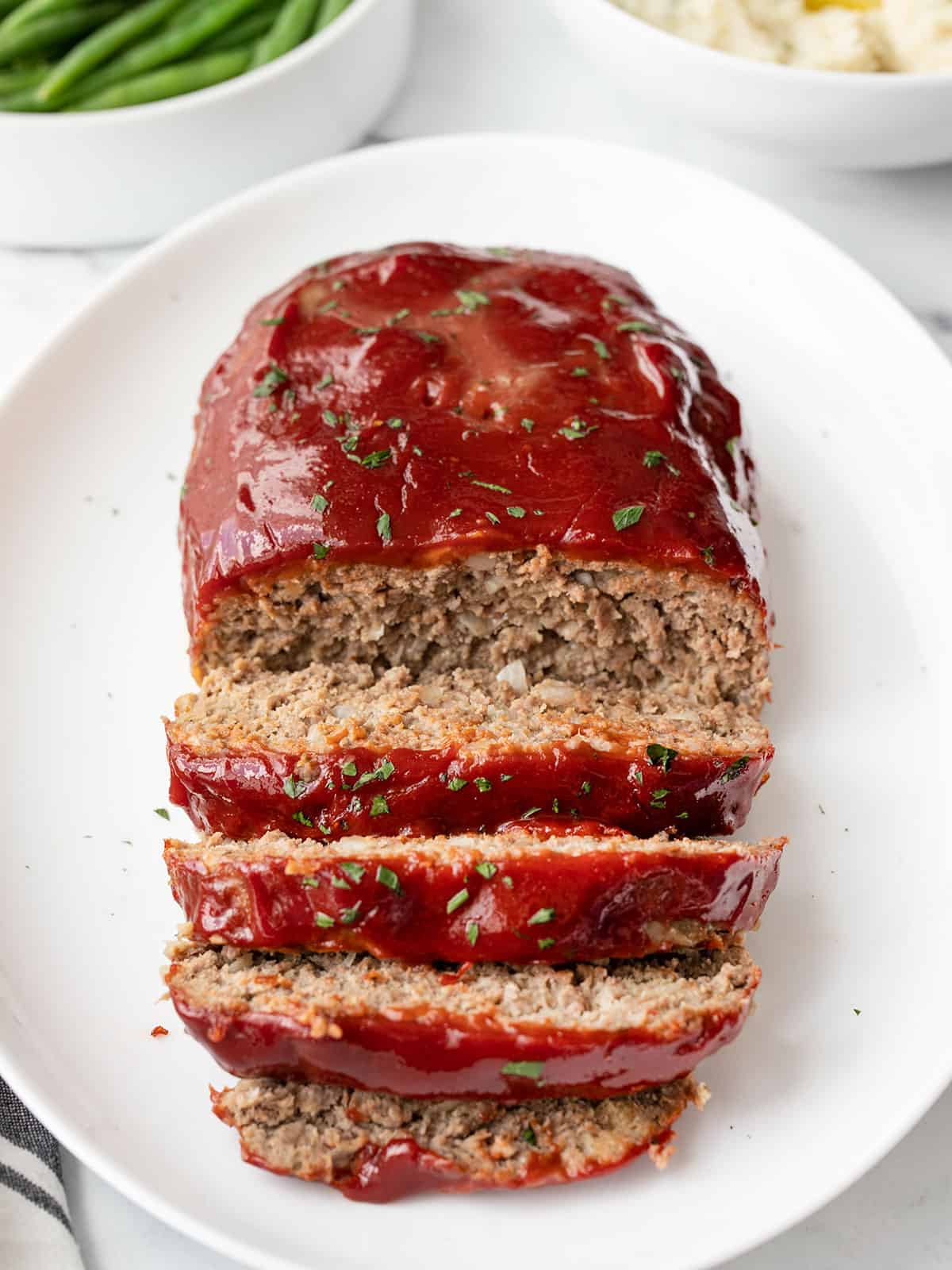 front view of a sliced meatloaf on a platter