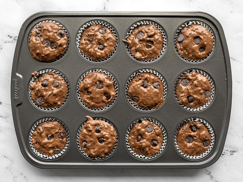 Muffin batter in the muffin tin, unbaked.