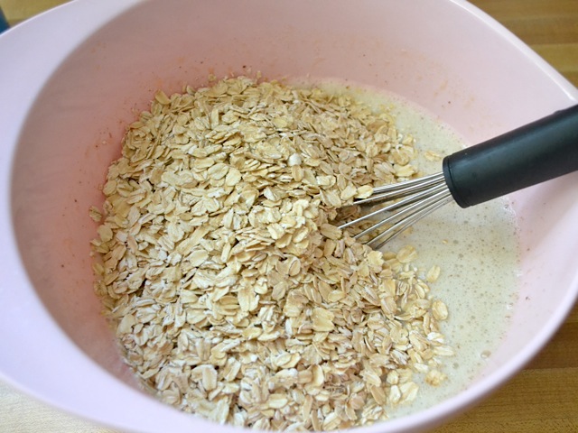 dry oats added into. mixing bowl with other ingredients 