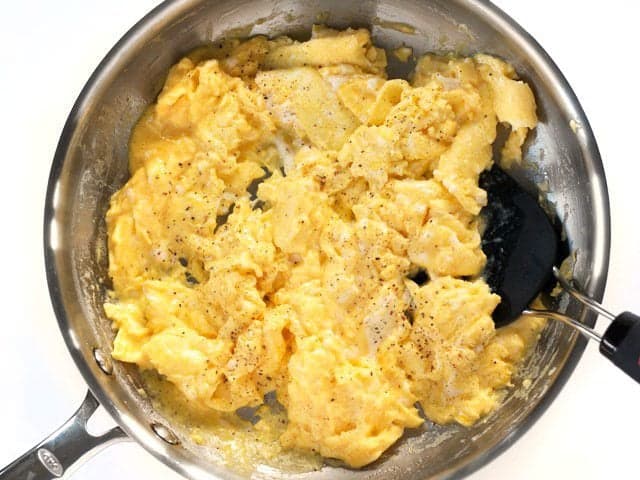 Lightly Scrambled Eggs in the skillet, topped with pepper