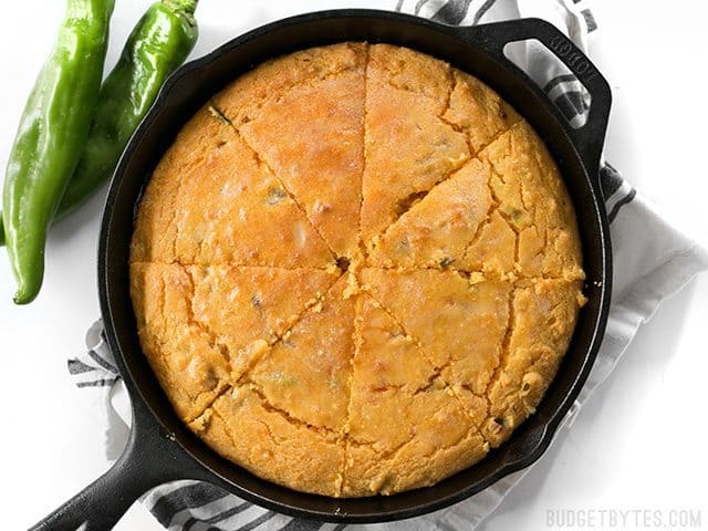 Top view of sliced Hatch Chile Sweet Potato Cornbread in cast iron skillet 