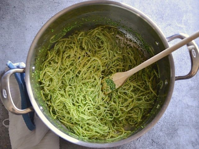 Pasta tossed and fully coated in pesto